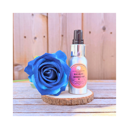 Blue rose and shower spray bottle on a wooden surface with a wooden background