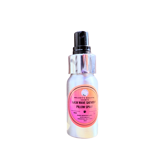 Bottle of 'Calm Wave Shower & Pillow Spray' with a pink label on a white background