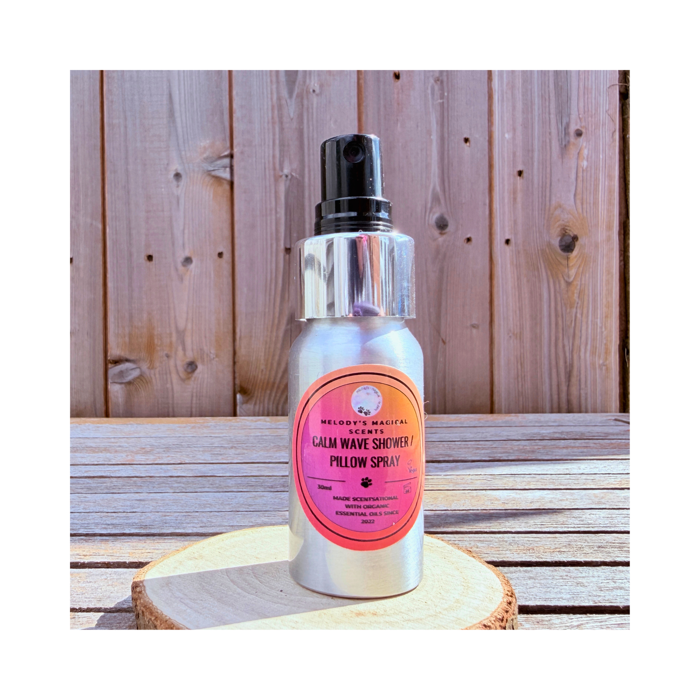 Silver spray bottle with pink label on a wooden surface "Calm Wave 30ml"