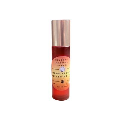 Roller bottle with red liquid and gold cap on a white background