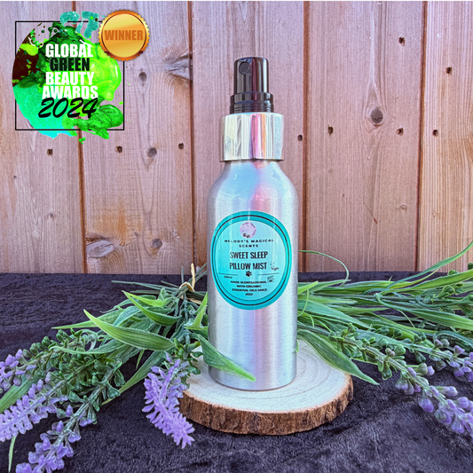 Silver bottle with green label on a wooden platform with lavender flowers, against a wooden panel background.
